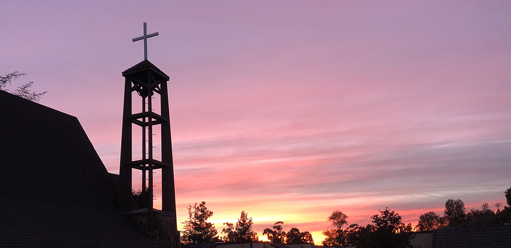 Golden red sunset behind the cross on top of our steeple.